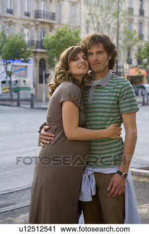 Pregnant young woman and young man standing in street, smiling, portrait View Large Photo Image Stock Image - Pregnant young woman and young man standing in street, smiling, portrait. Fotosearch