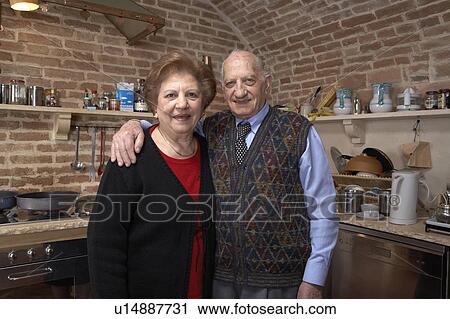Senior couple in kitchen, smiling, portrait View Large Photo Image Stock Image - Senior couple in kitchen, smiling, portrait. Fotosearch