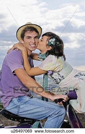 Woman kissing man on scooter. View Large Photo Image Stock Photo - Woman kissing man on scooter.. Fotosearch
