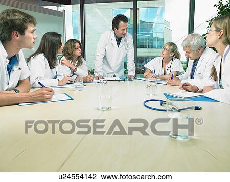 Business meeting of a group of doctors in a conference room around a table. View Large Photo Image Stock Image - Business meeting of a group of doctors in a conference room around a table.. Fotosearch