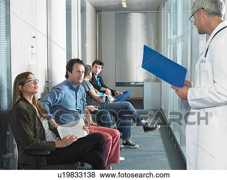 Male doctor calling for patients in hospital waiting room. View Large Photo Image Stock Photo - Male doctor calling for patients in hospital waiting room.. Fotosearch