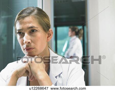 Portrait of female doctor with female doctor in background. View Large Photo Image Stock Photo - Portrait of female doctor with female doctor in background.. Fotosearch
