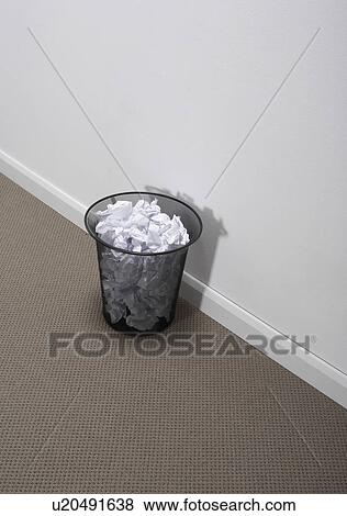 Stock Photo - A wastebasket full of papers.. Fotosearch