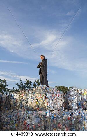 Stock Photo - Businessman outdoors at a recycling plant.. Fotosearch