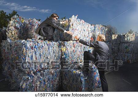 Businessmen climbing a wall of recycling. View Large Photo Image Picture - Businessmen climbing a wall of recycling.. Fotosearch