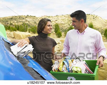 Couple placing papers in a recycle bin, husband holding box full of papers, Alicante, Spain, View Large Photo Image Stock Photo - Couple placing papers in a recycle bin, husband holding box full of papers, Alicante, Spain,. Fotosearch