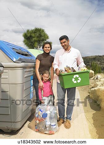 Couple posing with child and recycling objects next to bin, Alicante, Spain, View Large Photo Image Stock Image - Couple posing with child and recycling objects next to bin, Alicante, Spain,. Fotosearch
