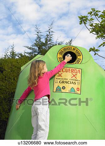 Low angle view of young girl (5-7) putting glass bottle in recycling bin, Alicante, Spain, View Large Photo Image Stock Image - Low angle view of young girl (5-7) putting glass bottle in recycling bin, Alicante, Spain,. Fotosearch