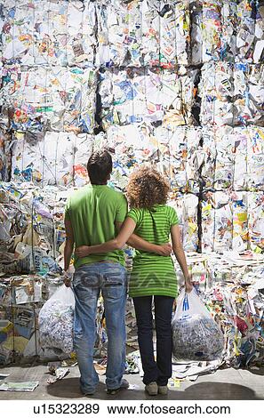 Stock Photo - Man and woman at a recycling plant.. Fotosearch