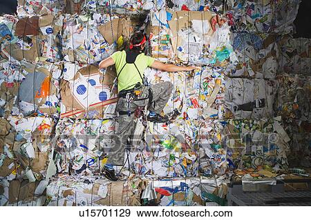 Man climbing a wall of recycling. View Large Photo Image Stock Photo - Man climbing a wall of recycling.. Fotosearch