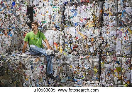 Man sitting down at a recycling plant. View Large Photo Image Stock Photography - Man sitting down at a recycling plant.. Fotosearch