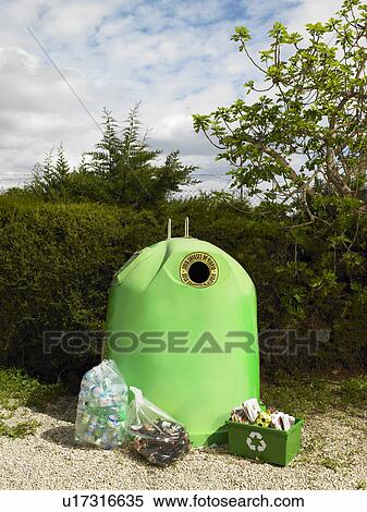 Stock Photography - Recycle bin surrounded by items ready for recycling, Alicante, Spain,. Fotosearch