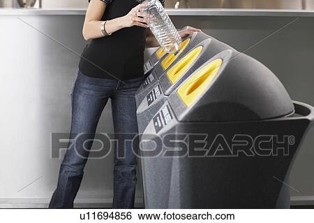 Woman recycling a plastic bottle View Large Photo Image Stock Photograph - Woman recycling a plastic bottle. Fotosearch