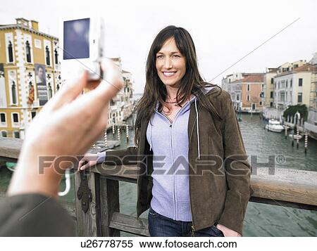 Close up of man's hand taking photograph of woman. Grand Canal, Venice, Italy. View Large Photo Image Stock Photography - Close up of man's hand taking photograph of woman. Grand Canal, Venice, Italy.. Fotosearch