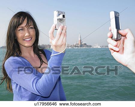 Couple taking photos of each other. Venice, Italy. View Large Photo Image Stock Photograph - Couple taking photos of each other. Venice, Italy.. Fotosearch