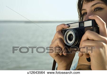 Picture - Girl holding camera.. Fotosearch