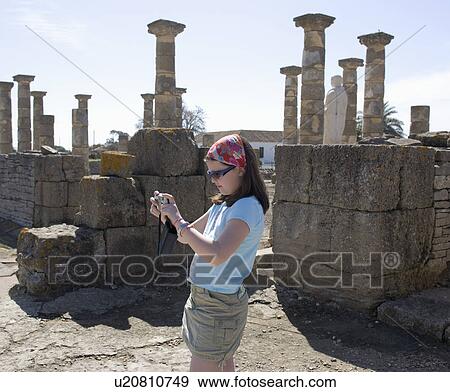 Stock Photo - Girl taking picture in roman ruins.. Fotosearch
