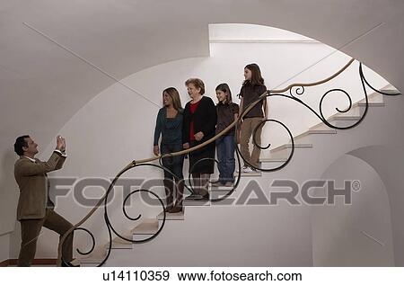 Three generation family on staircase posing for photograph View Large Photo Image Stock Photo - Three generation family on staircase posing for photograph. Fotosearch