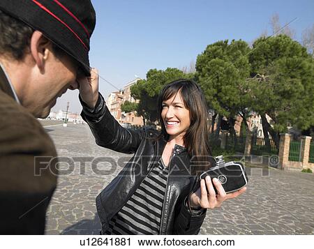 Woman preparing to take photograph of man with old 8mm camera. Venice, Italy. View Large Photo Image Stock Image - Woman preparing to take photograph of man with old 8mm camera. Venice, Italy.. Fotosearch