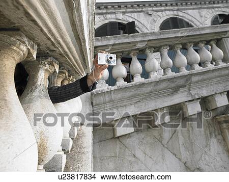 Woman's hand holding digital camera taking photograph through stone parapet of Rialto Bridge. Venice, Italy. View Large Photo Image Picture - Woman's hand holding digital camera taking photograph through stone parapet of Rialto Bridge. Venice, Italy.. Fotosearch
