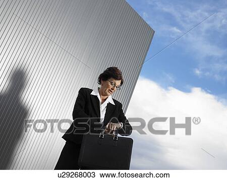 Businesswoman by a silver wall. View Large Photo Image Stock Image - Businesswoman by a silver wall.. Fotosearch