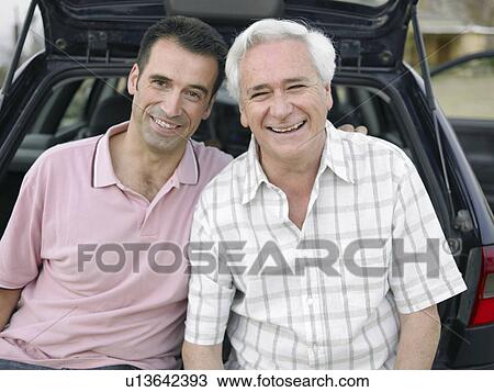 Senior man and adult son resting against open boot of parked car, portrait View Large Photo Image Stock Image - Senior man and adult son resting against open boot of parked car, portrait. Fotosearch