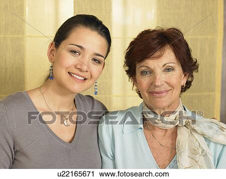 Stock Image - Senior mother and daughter, smiling, portrait, close-up. Fotosearch