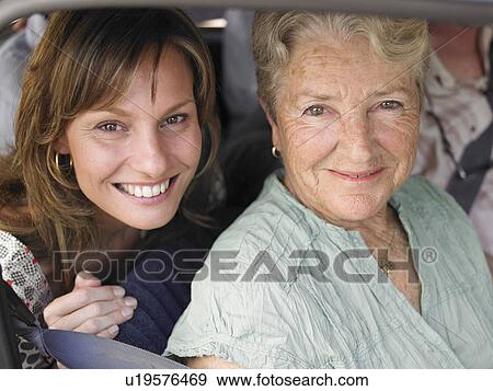 Senior woman and adult daughter sitting in car, smiling, portrait View Large Photo Image Stock Photo - Senior woman and adult daughter sitting in car, smiling, portrait. Fotosearch