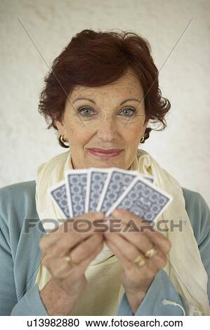 Senior woman holding playing cards, smiling, portrait View Large Photo Image Stock Image - Senior woman holding playing cards, smiling, portrait. Fotosearch