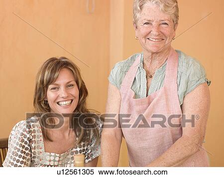 Senior woman standing beside adult daughter at home, smiling, portrait View Large Photo Image Stock Photography - Senior woman standing beside adult daughter at home, smiling, portrait. Fotosearch
