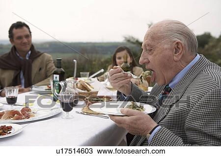 Three generation family eating outdoors View Large Photo Image Stock Image - Three generation family eating outdoors. Fotosearch