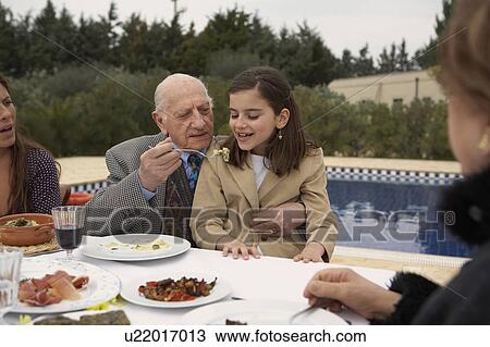 Three generation family eating outdoors View Large Photo Image Stock Image - Three generation family eating outdoors. Fotosearch