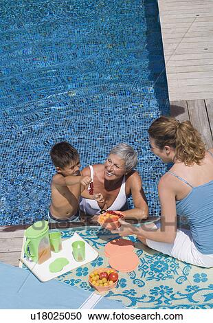 Stock Image - Woman and boy in swimming pool.. Fotosearch