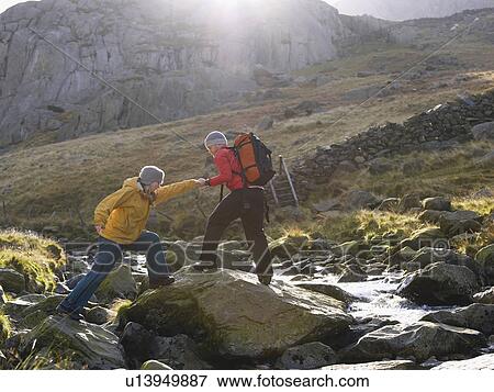 Stock Photo - Couple helping one another.. Fotosearch