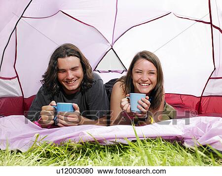 Couple with mugs in pink tent View Large Photo Image Stock Image - Couple with mugs in pink tent. Fotosearch