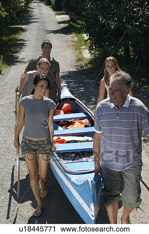People on a path carrying a canoe. View Large Photo Image Stock Image - People on a path carrying a canoe.. Fotosearch