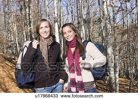 Stock Image - Portrait of 2 young women in the woods.. Fotosearch