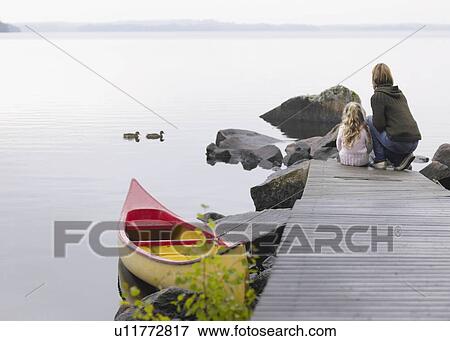 Woman and young girl on a dock near a boat. View Large Photo Image Stock Photo - Woman and young girl on a dock near a boat.. Fotosearch