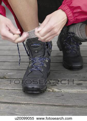 Stock Photography - Woman's shoes being laced up.. Fotosearch