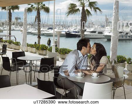 Stock Image - Couple being affectionate in a restaurant.. Fotosearch