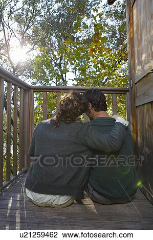 Couple sitting on deck. View Large Photo Image Stock Image - Couple sitting on deck.. Fotosearch