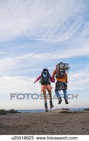 Stock Image - Man and woman holding hands.. Fotosearch