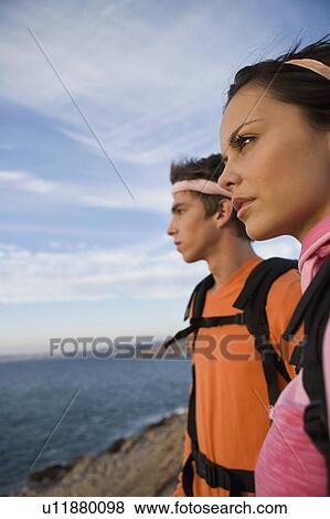 Stock Photo - Man and woman looking out to sea.. Fotosearch