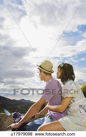 Stock Photo - Man and woman on scooter.. Fotosearch