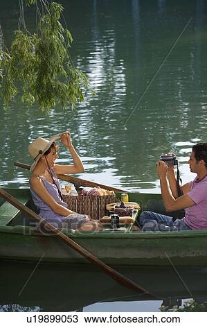 Man filming a woman on boat View Large Photo Image Stock Image - Man filming a woman on boat. Fotosearch