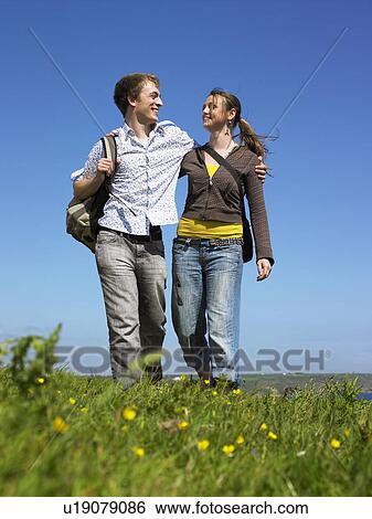Young couple outdoors holding hands. View Large Photo Image Stock Photograph - Young couple outdoors holding hands.. Fotosearch