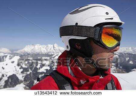 Austria, Saalbach, male skier wearing helmet and goggles, close-up View Large Photo Image Stock Image - Austria, Saalbach, male skier wearing helmet and goggles, close-up. Fotosearch