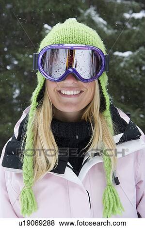 Close-up portrait of young blonde woman wearing ski-wear in forest View Large Photo Image Stock Photo - Close-up portrait of young blonde woman wearing ski-wear in forest. Fotosearch