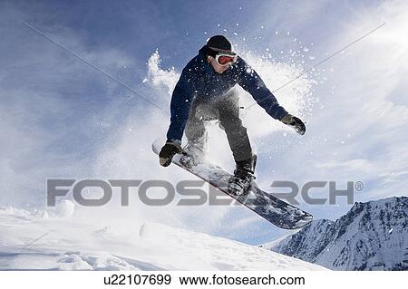 Male snowboarding on mountain, action shot View Large Photo Image Stock Photo - Male snowboarding on mountain, action shot. Fotosearch