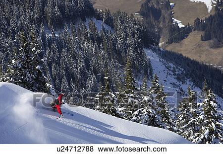 Stock Photo - Man skiing down snow mountain slope, overhead view. Fotosearch